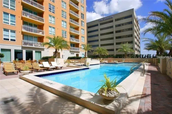 a swimming pool with outdoor seating and yard