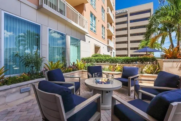 a view of a patio with couches chairs and a fire pit