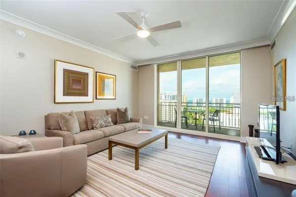 a living room with furniture and a floor to ceiling window