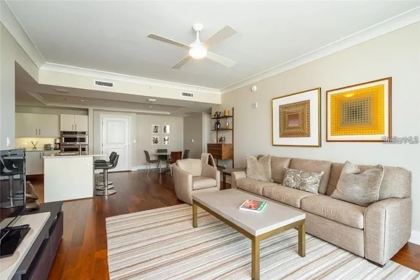 a living room with furniture and a wooden floor