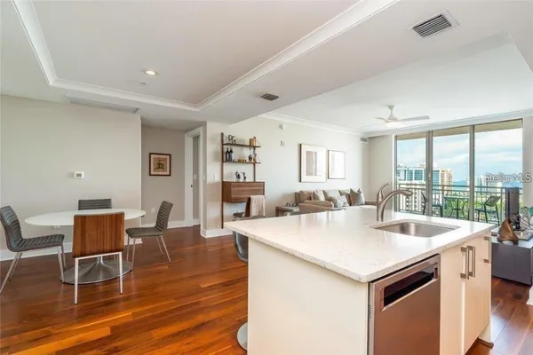 a kitchen with a table chairs and wooden floor