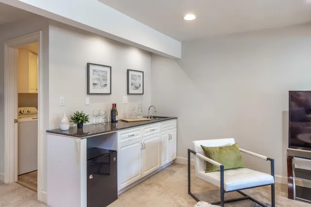 a living room with furniture and painting on the wall