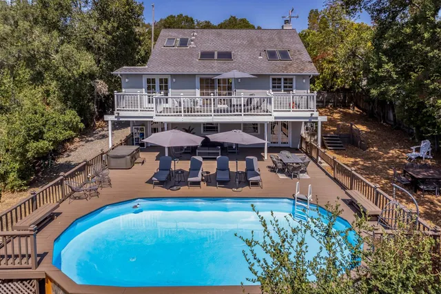 an aerial view of a house with swimming pool garden and patio