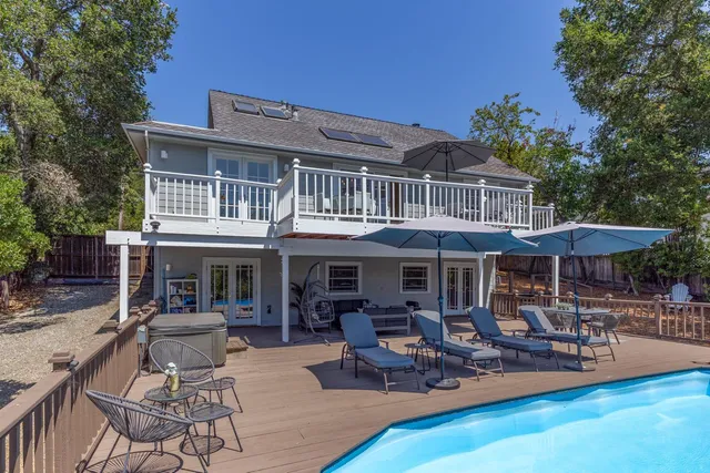 a patio with a table and chairs under an umbrella