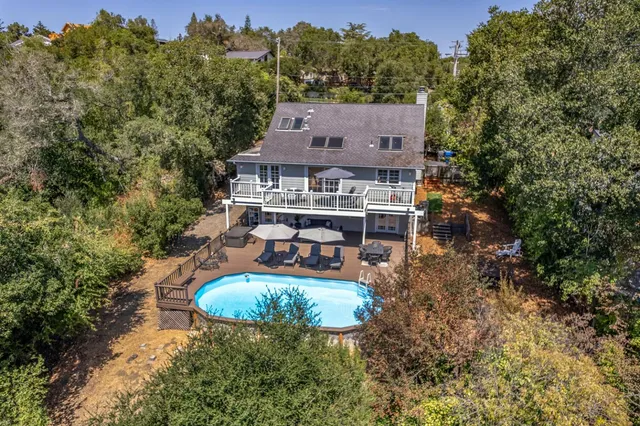 an aerial view of a house with yard swimming pool and outdoor seating