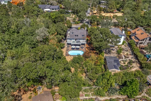 an aerial view of a houses with yard