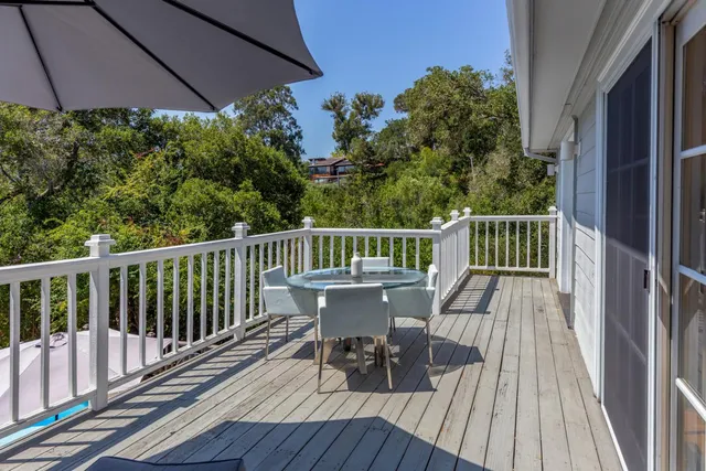 a view of balcony with furniture and wooden floor