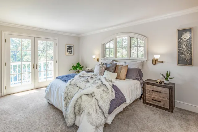 a spacious bedroom with a bed and a large window