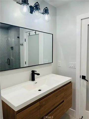 a bathroom with a shower and a sink