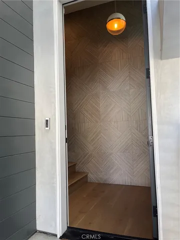 a living room with stainless steel appliances kitchen island granite countertop a sink and cabinets