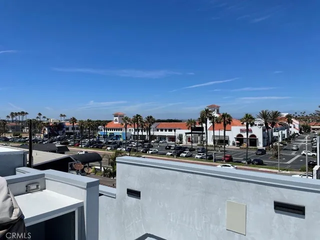 a view of empty room with wooden floor and window