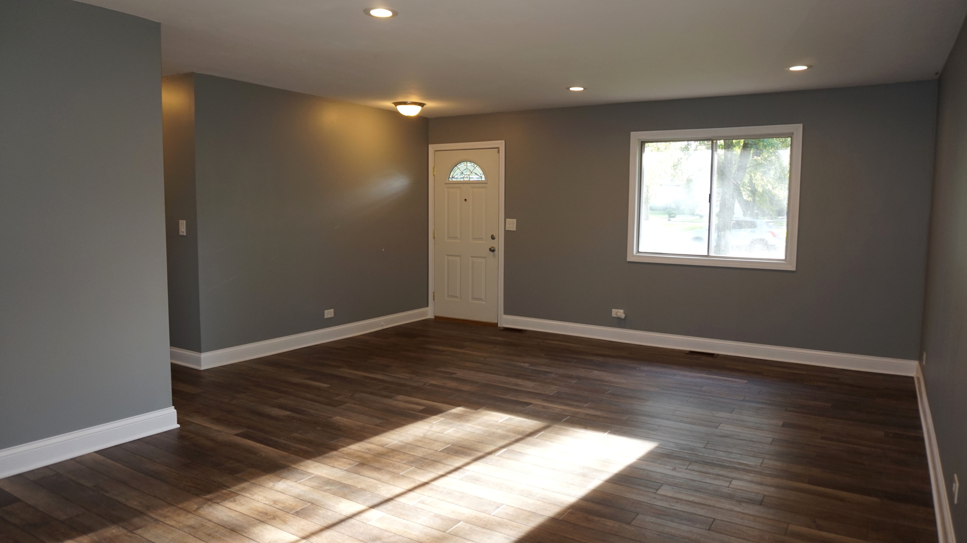 5740 Timberlane Road Matteson, IL 60443 - Photo 4 of 17 an empty room with wooden floor and windows