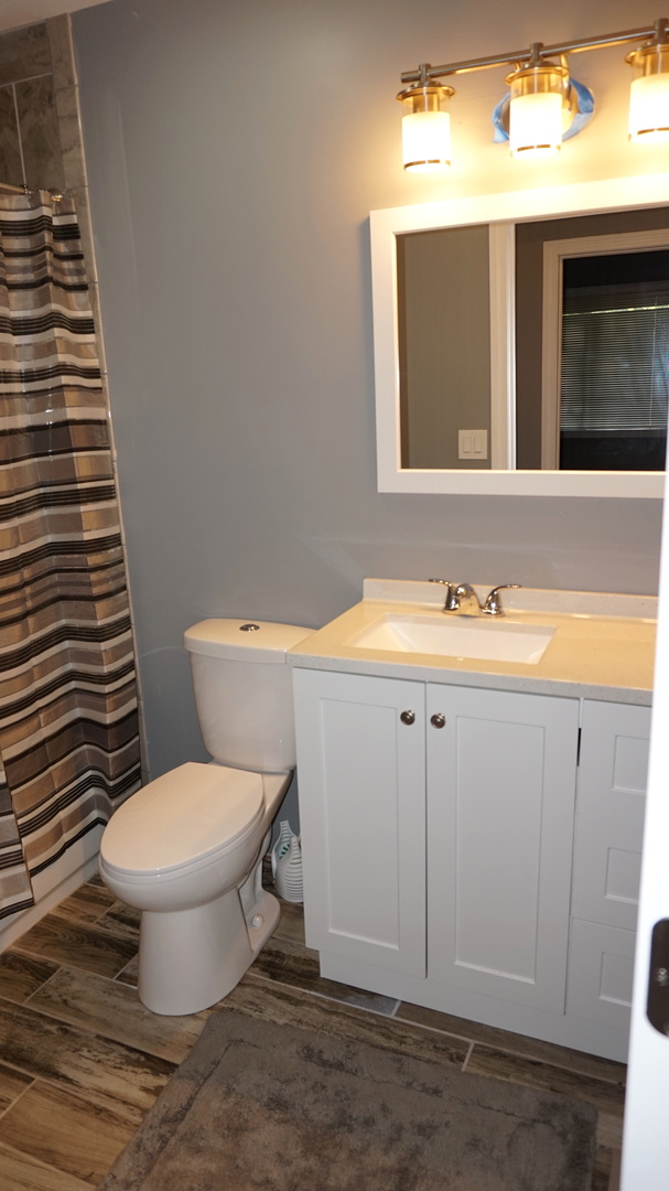 5740 Timberlane Road Matteson, IL 60443 - Photo 10 of 17 a bathroom with a sink toilet and mirror