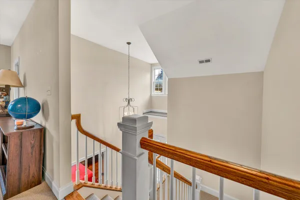 a bedroom with a large bed and windows