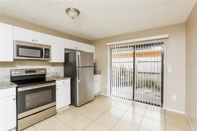 a kitchen with stainless steel appliances granite countertop a refrigerator stove a sink and dishwasher