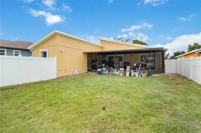 a view of a patio with table and chairs under an umbrella