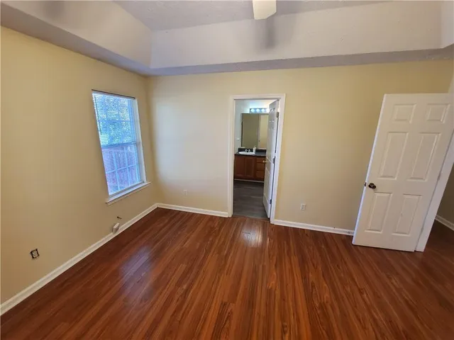 an empty room with wooden floor and closet