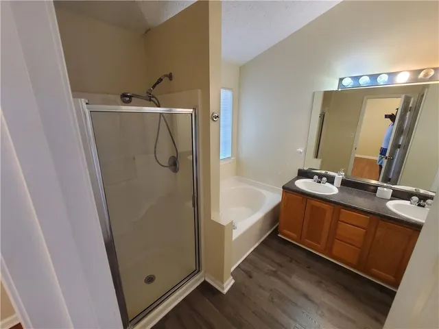 a bathroom with a tub sink and mirror