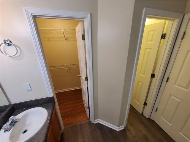 a view of bathroom with sink mirror and window