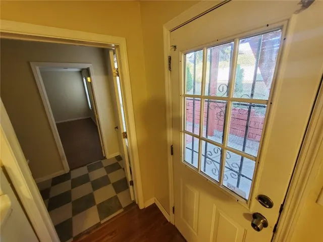 a wooden bench sitting in front of a building