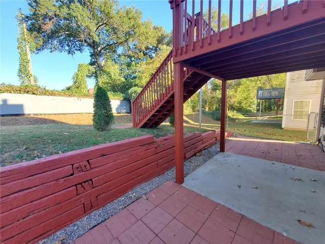 a view of a house with backyard and sitting area