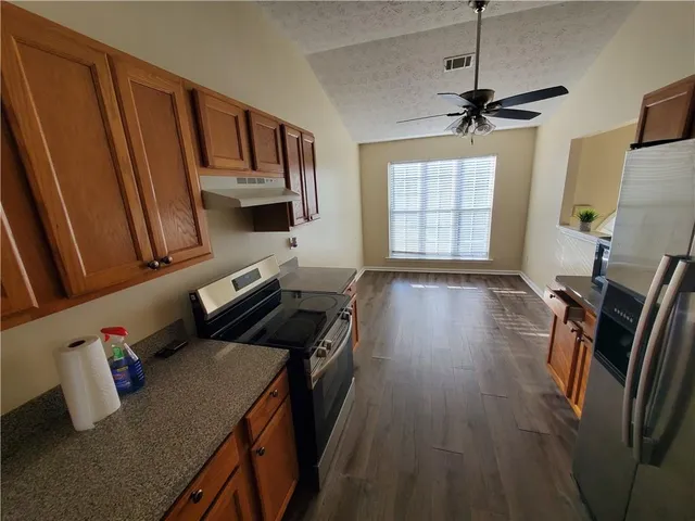 a kitchen with sink refrigerator and window