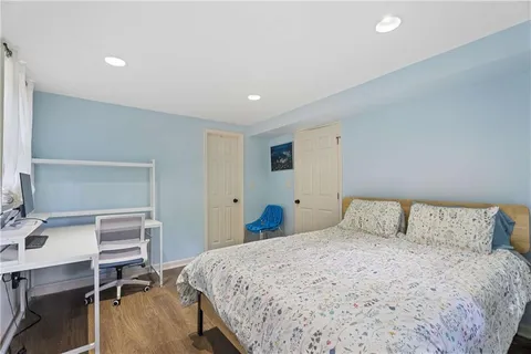 a bedroom with a bed and a desk