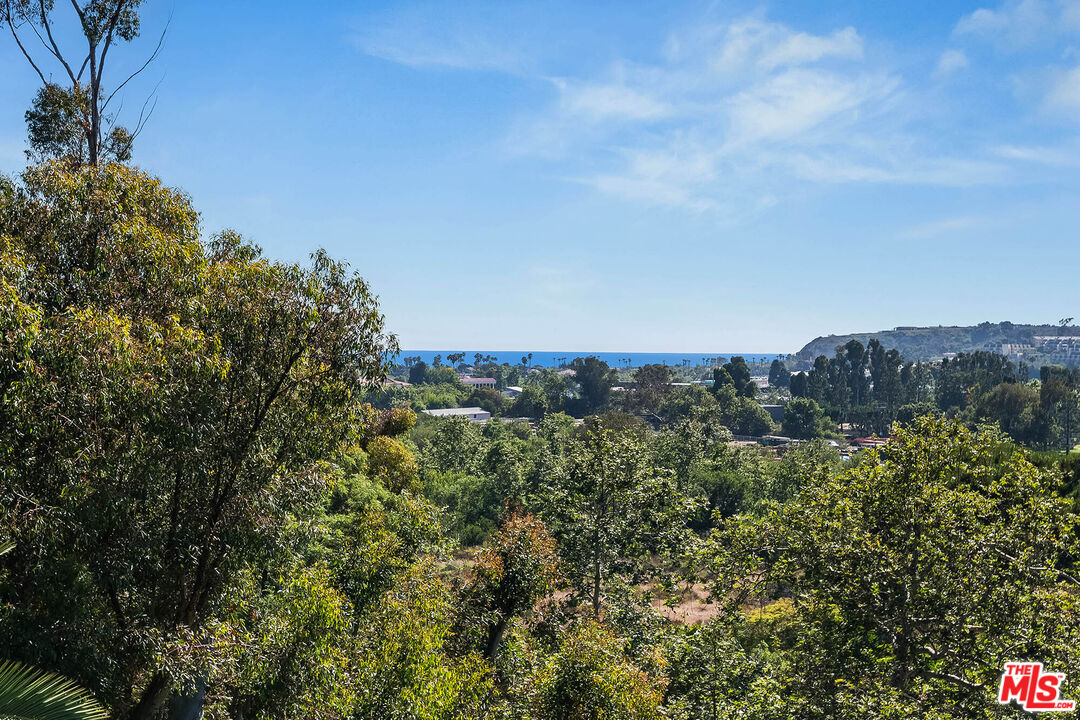 3557 Serra Road Malibu, CA 90265 - Photo 11 of 32 a view of a large building with a mountain in the background