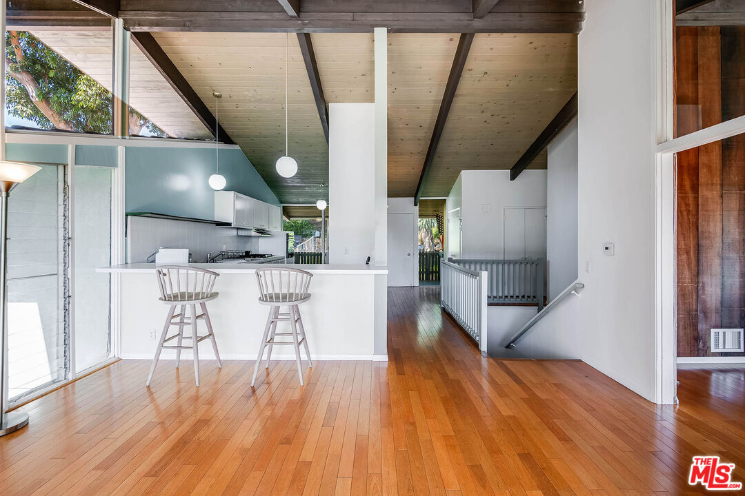 3557 Serra Road Malibu, CA 90265 - Photo 13 of 32 a dining room with wooden floor table and chairs