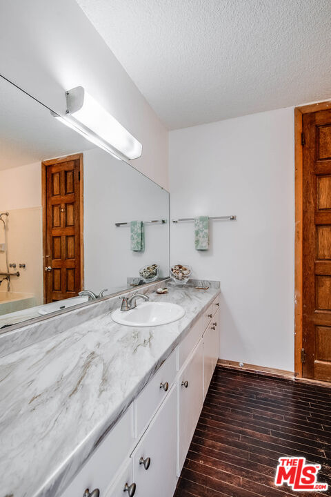 3557 Serra Road Malibu, CA 90265 - Photo 27 of 32 a bathroom with a sink and a mirror