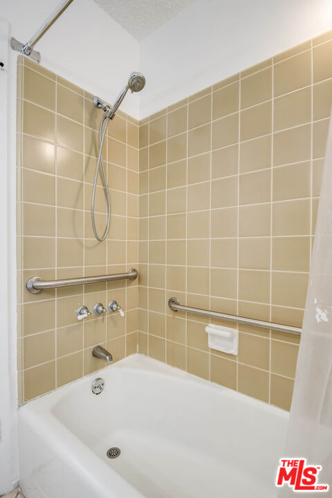 3557 Serra Road Malibu, CA 90265 - Photo 31 of 32 a bathroom with a bathtub and a shower