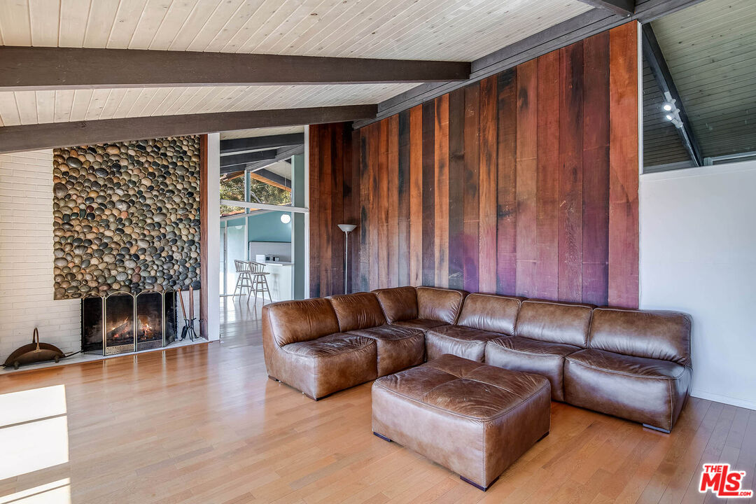 3557 Serra Road Malibu, CA 90265 - Photo 8 of 32 a living room with furniture and a fireplace