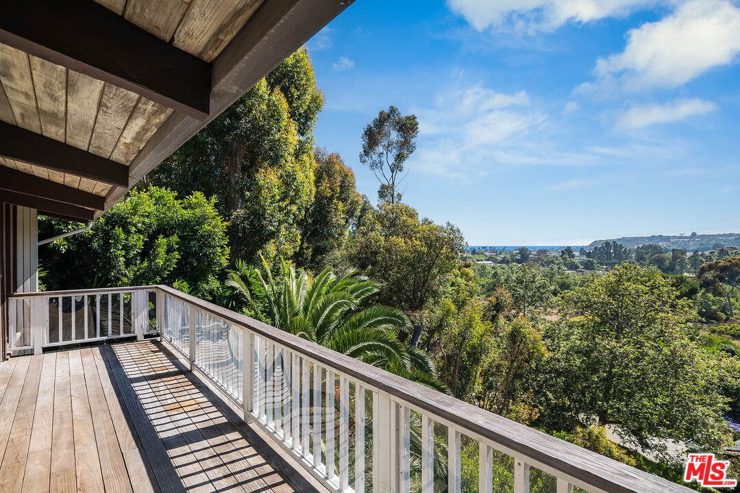 3557 Serra Road Malibu, CA 90265 - Photo 10 of 32 a view of a balcony with wooden floor