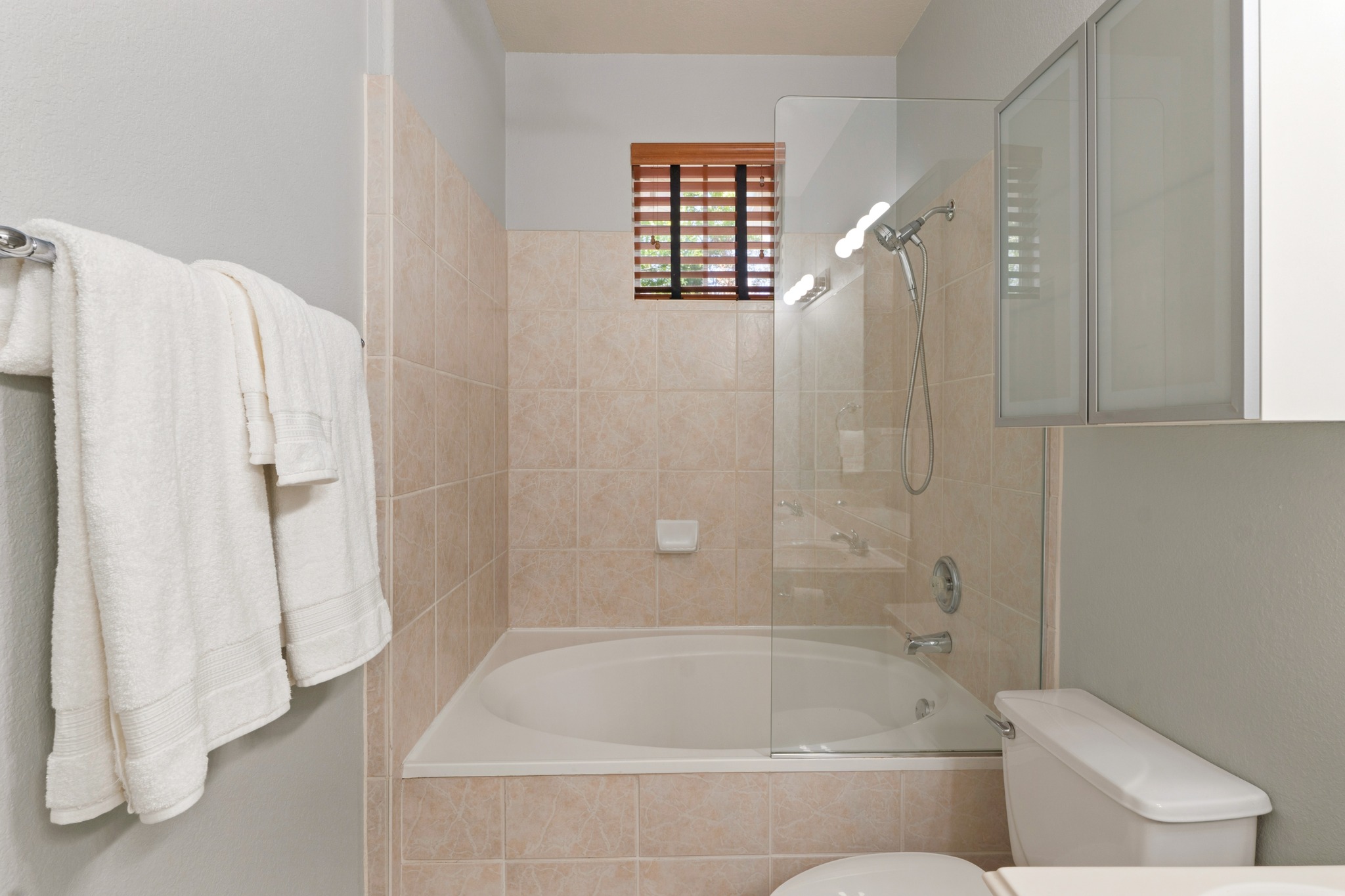 4508 Duval Road, Unit 604 Austin, TX 78727 - Photo 16 of 34 Unwind after a long day in the primary bath, which offers a full tub and shower combination with updated fixtures and wrap around tile