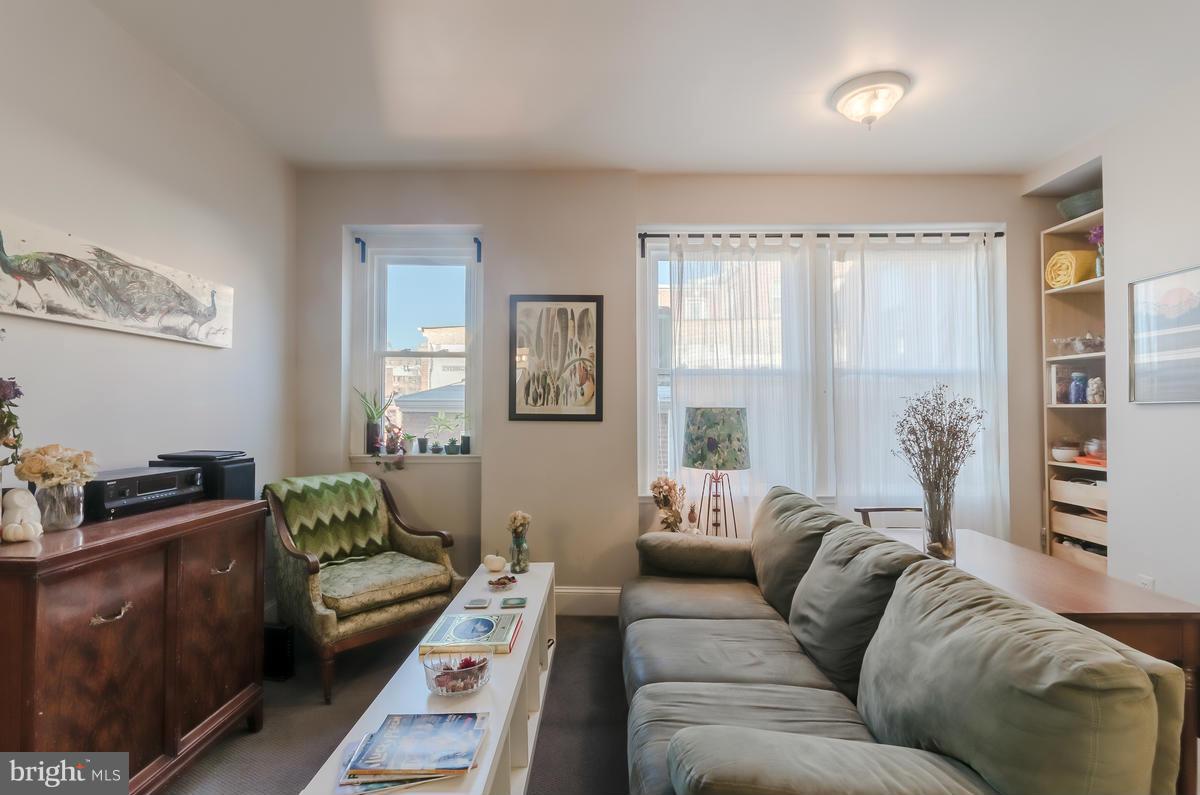 2008 16th Street Northwest, Unit 302 Washington, DC 20009 - Photo 2 of 11 a living room with furniture and a window