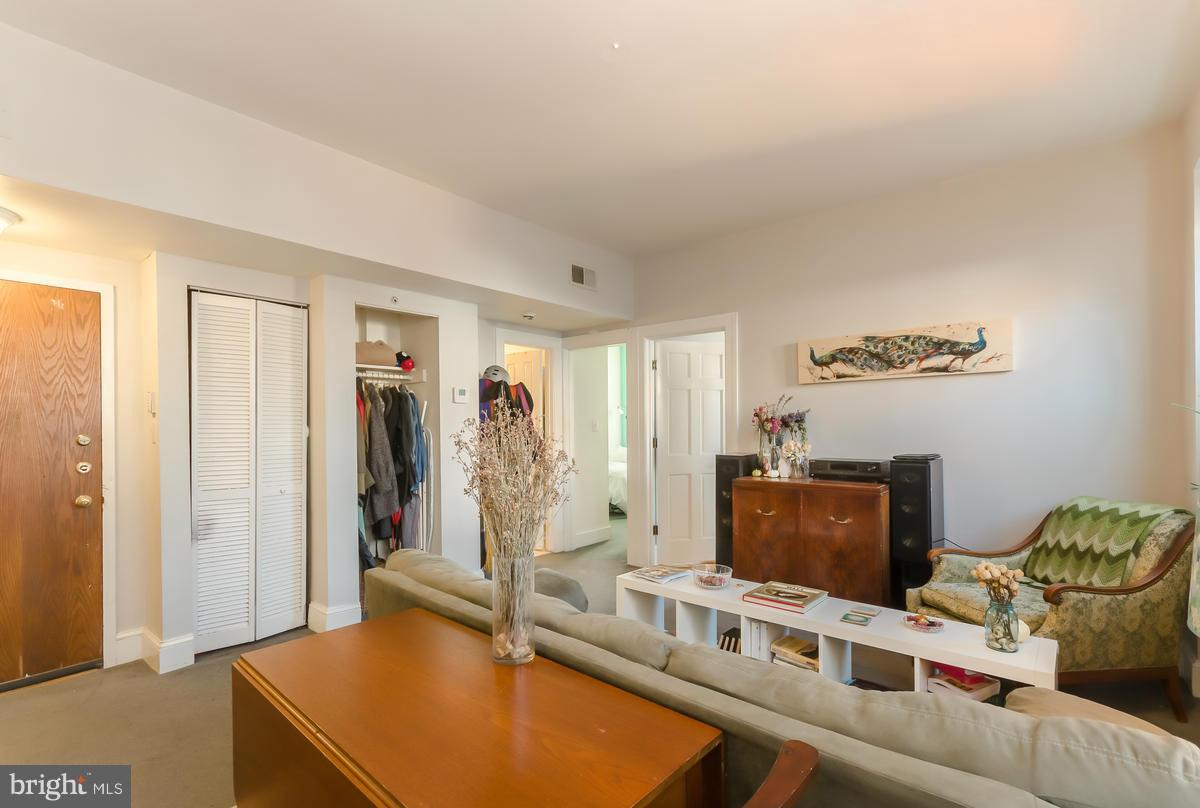 2008 16th Street Northwest, Unit 302 Washington, DC 20009 - Photo 4 of 11 a living room with furniture a flat screen tv and a refrigerator