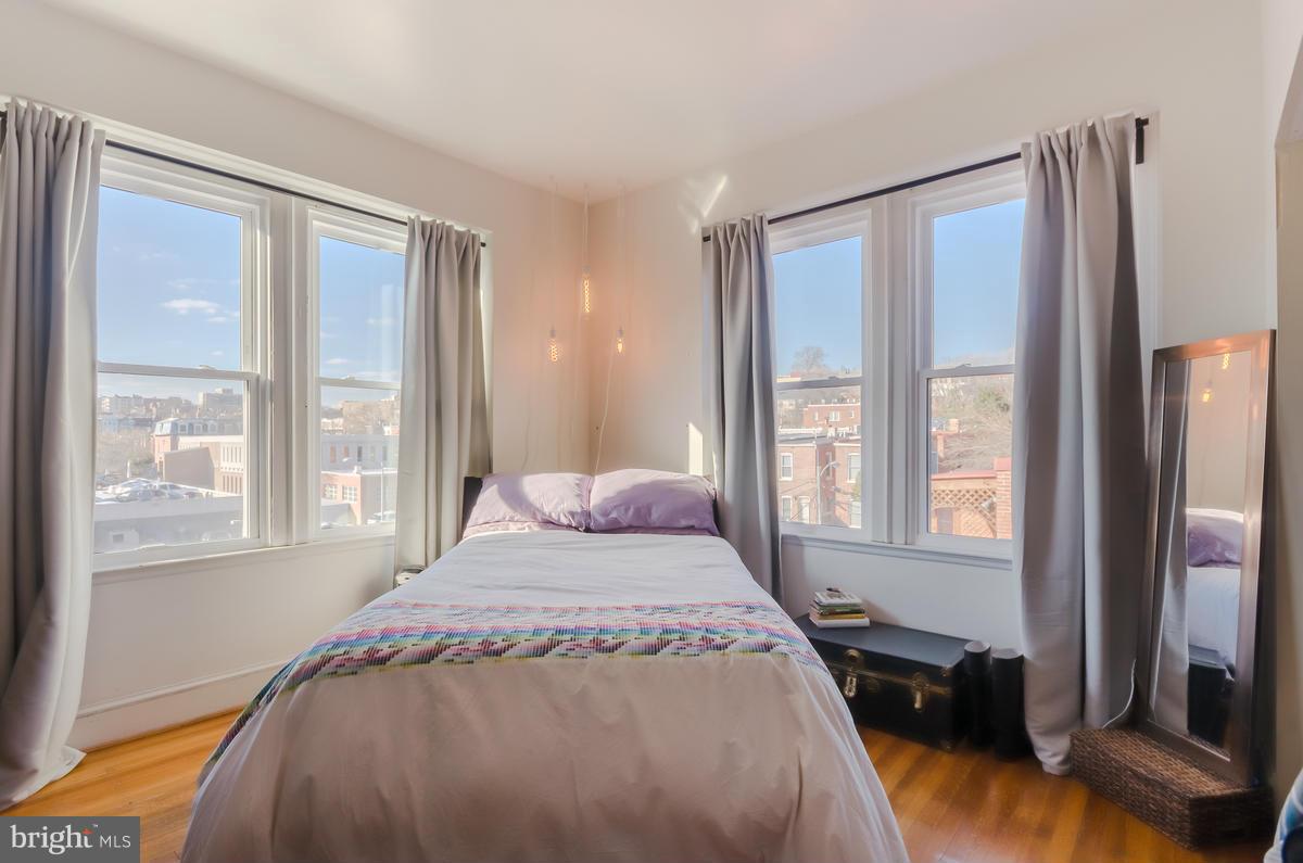 2008 16th Street Northwest, Unit 302 Washington, DC 20009 - Photo 7 of 11 a bedroom with a bed and a large window