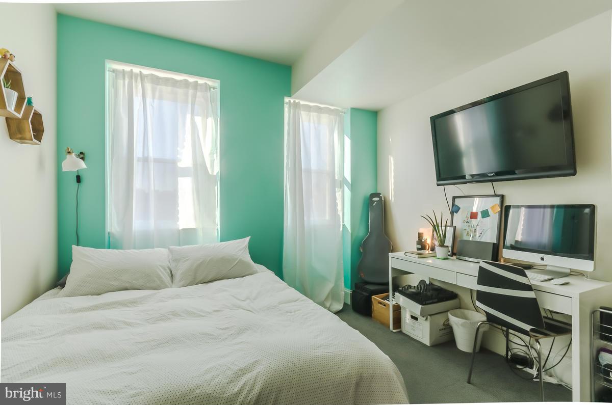 2008 16th Street Northwest, Unit 302 Washington, DC 20009 - Photo 9 of 11 a bedroom with a bed and a flat screen tv