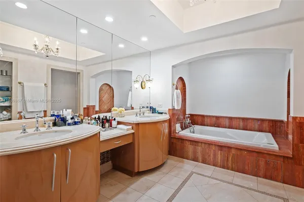 a bathroom with a tub sink and mirror