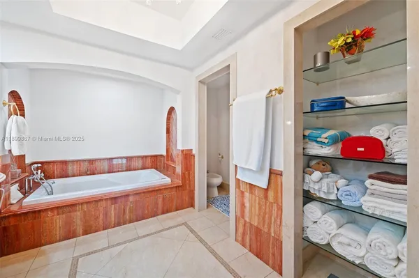 a bathroom with a tub and shower