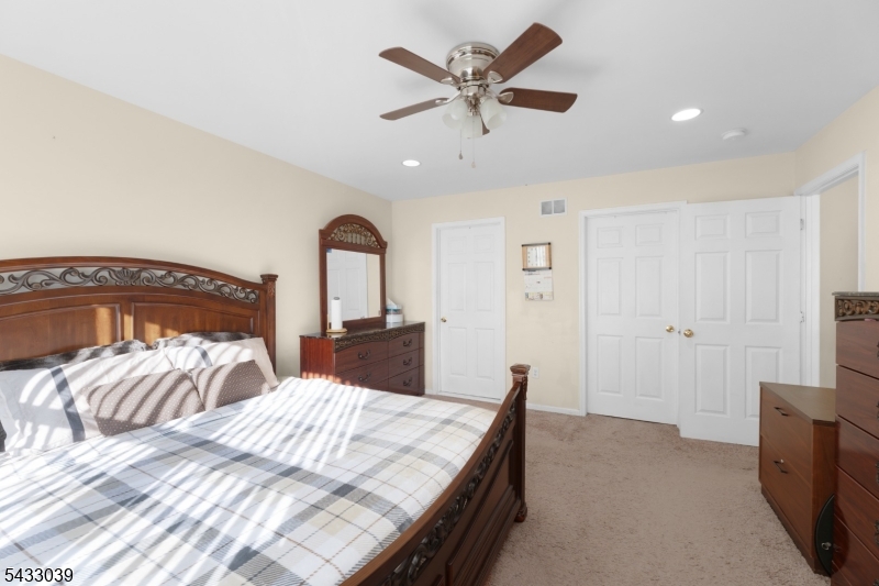 158 Autumn Ridge Road Morris Plains, NJ 07950 - Photo 22 of 26 a bedroom with a bed and a chandelier