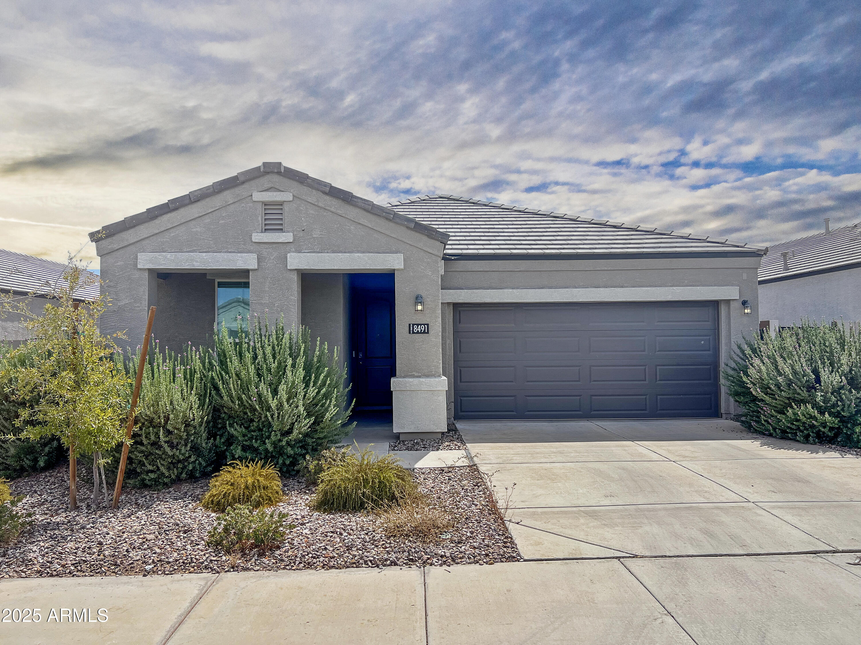 a front view of house with garage and yard