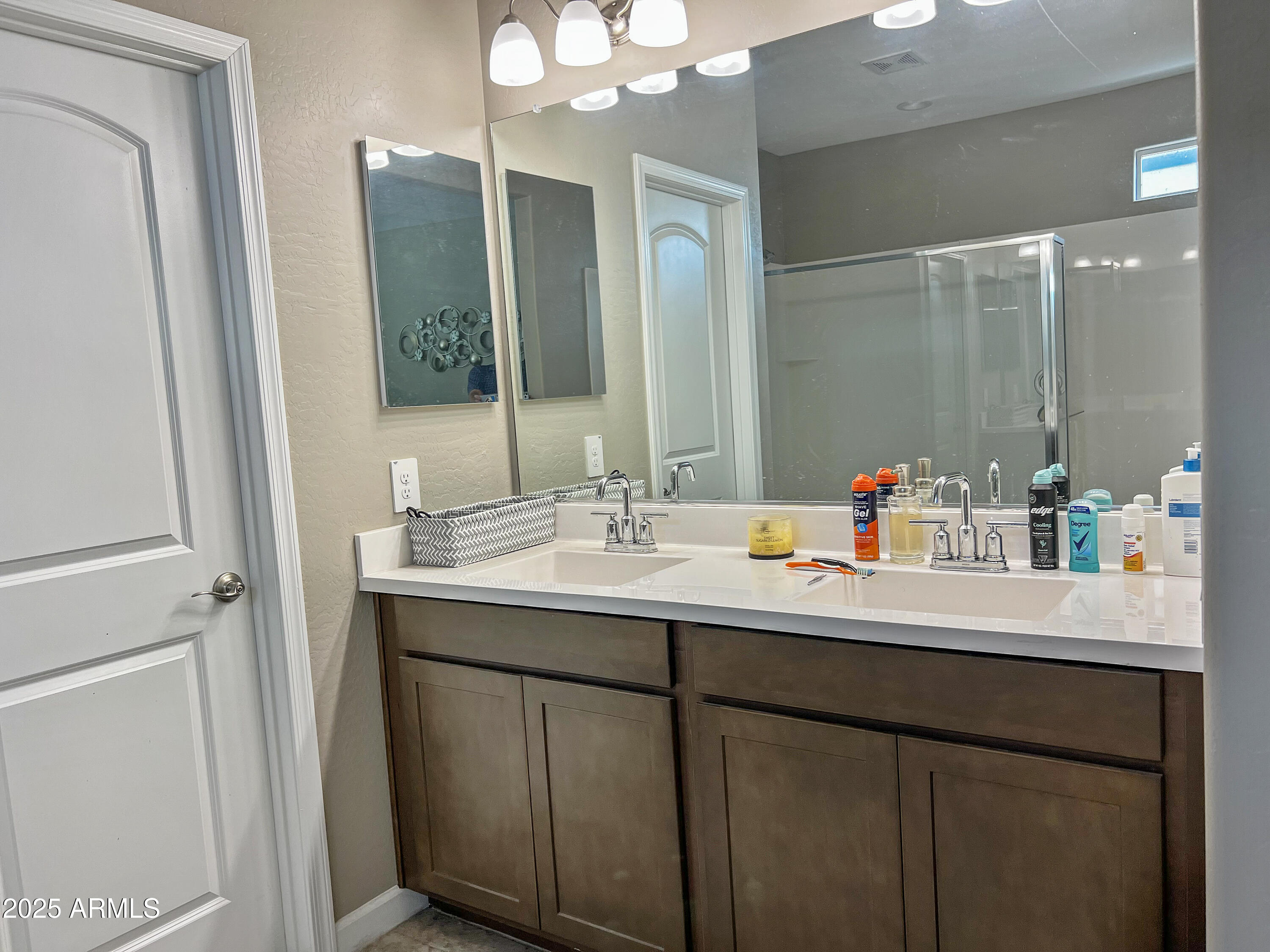 8491 West Springfield Way Florence, AZ 85132 - Photo 31 of 34 a bathroom with a sink and a mirror