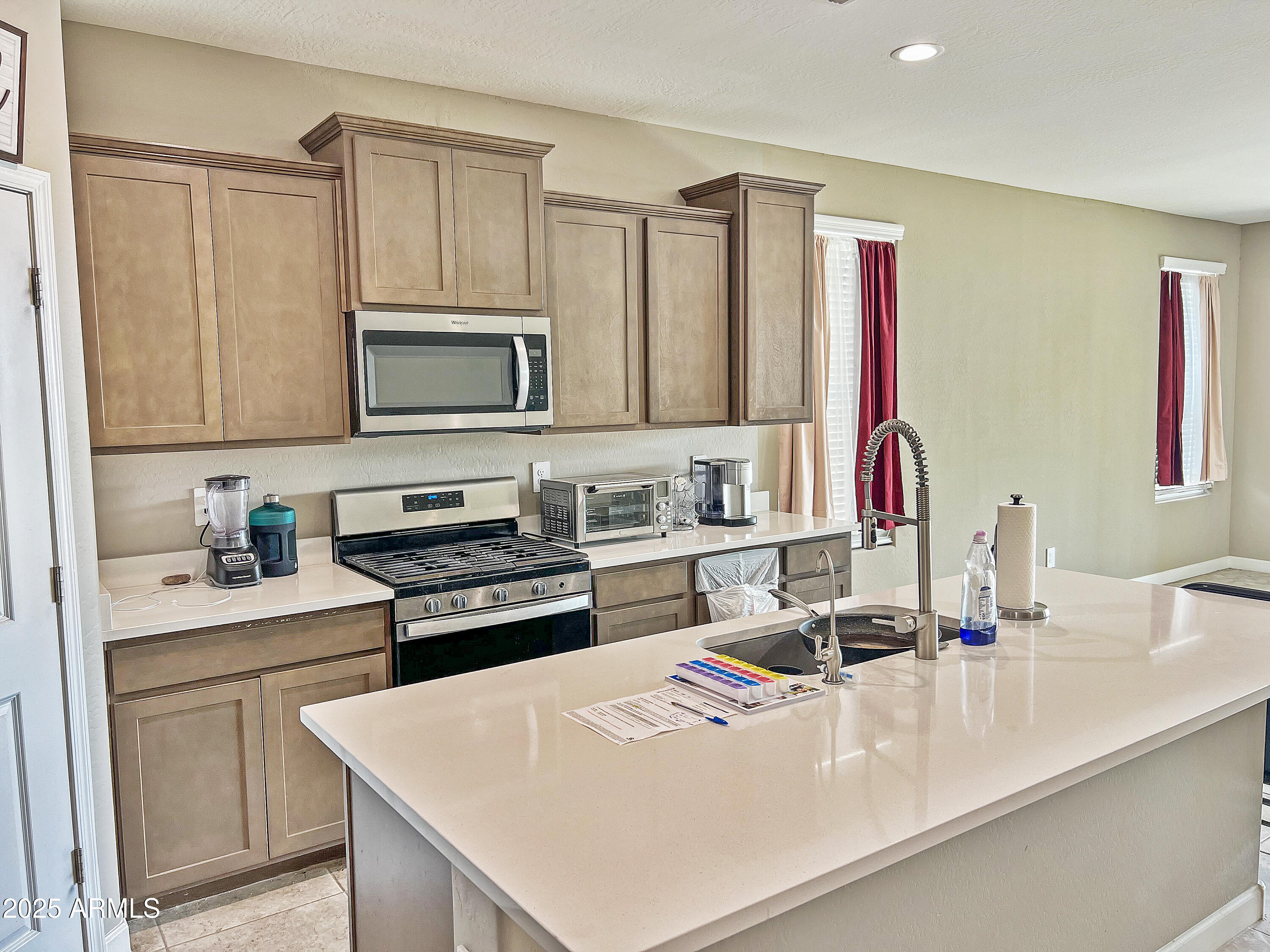 8491 West Springfield Way Florence, AZ 85132 - Photo 9 of 34 a kitchen with a sink a stove and cabinets