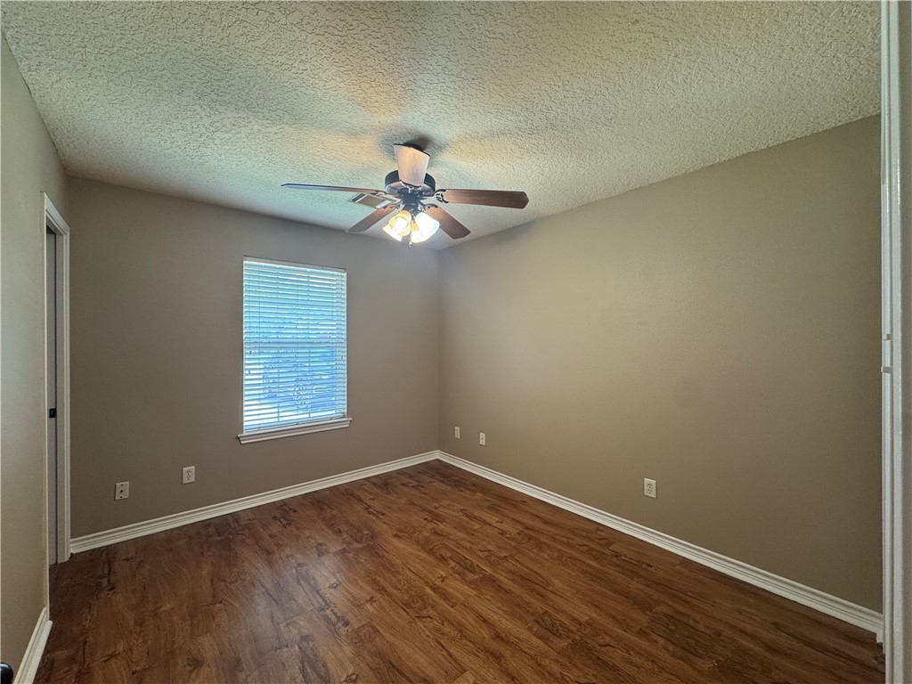 124 Sterling Street College Station, TX 77840 - Photo 12 of 13 an empty room with wooden floor and windows