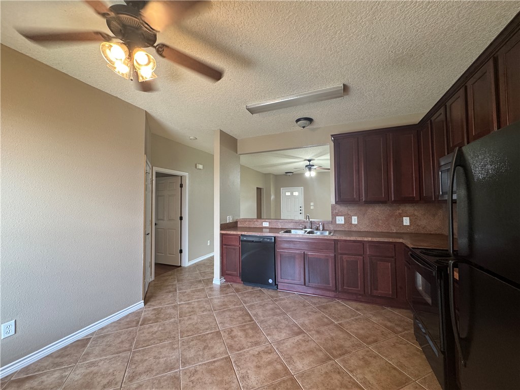 124 Sterling Street College Station, TX 77840 - Photo 6 of 13 a large kitchen with a stove and cabinets