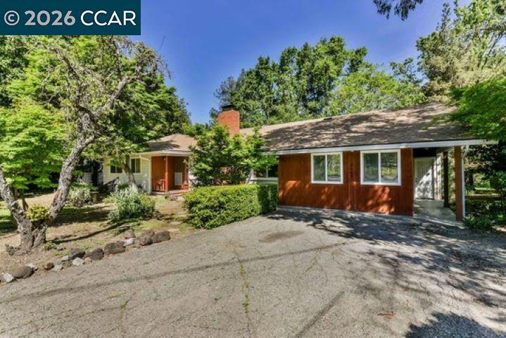 2648 Reliez Valley Road Martinez, CA 94553 - Photo 1 of 38 a front view of a house with a garden