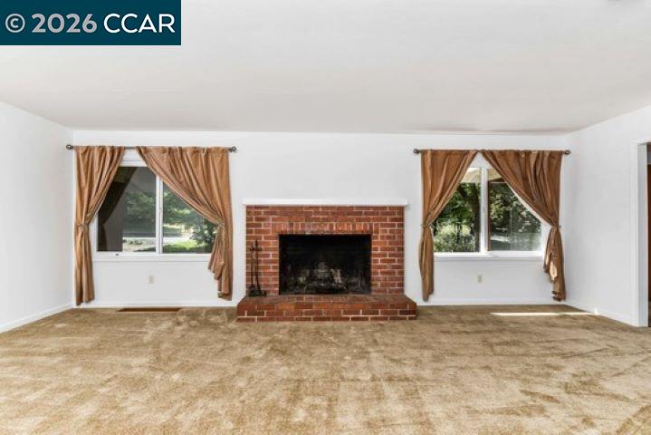 2648 Reliez Valley Road Martinez, CA 94553 - Photo 6 of 38 a view of an empty room with a fireplace and a window