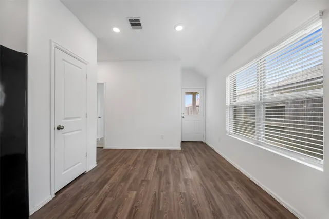 a large kitchen with kitchen island a stove a sink dishwasher and wooden floor