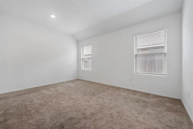 a bedroom with bed and a window